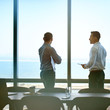 © marvent - Executives talking business in a office tower boardroom