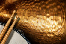 Close-up Of Two Wooden Drumsticks On An Old Metallic Snare Drum And Golden Colored Cymbal With Copy Space. Percussion Instrument