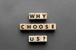© SecondSide - why choose us? - words from wooden blocks with letters, top view gray background