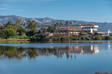 Goleta, CA, USA - January 2, 2020: UCSB, University California Santa Barbara. Marine Biotech Lab, Technology And Operations Facilities Seen From Behind Campus Lagoon. Blue Water And Sky. Green Foliage