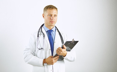 Wall Mural - Young confident doctor in a white coat with a stethoscope