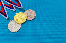 Gold Silver And Bronze Medal On Blue Background. Medal Schedule Concept Photo, Empty Edit Space. Original Wallpaper For Summer Olympic Game In Tokyo 2020