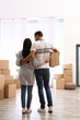 © New Africa - Couple in room with cardboard boxes on moving day