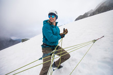 Mountaineer Using Z-haul To Pull Climber Out Of Crevasse In Mountains.