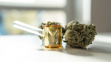 Glass Smoking Pipe And Marijuana Buds Close-up.