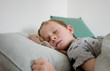 © Cavan Images - young boy sleeping with his bear in bed at home
