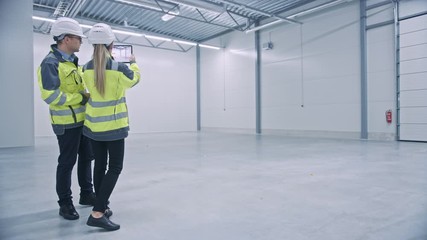 Poster - Industry 4.0 Modern Factory: Two Engineers Use Digital Tablet Computer with Augmented Reality Software Visualizing of Manufacturing Plant Room Mapping, Factory Layout. Illustrative Mock-up Concept