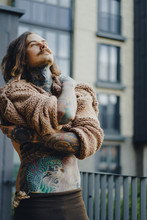 Handsome Tattooed Sexy Man With Long Hair And Mustache Outdoors