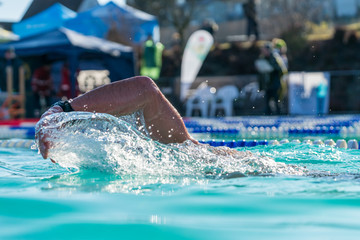 Athlete swimming in clear blue water