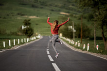 WOMAN JUMPING ON ROAD