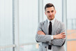 © Andrii - Confident young businessman standing with his hands folded, looking at the camera, ready to hard work day.