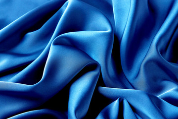 blue sapphire color silk fabric background, top view.