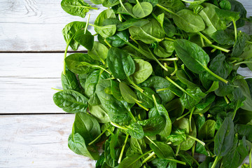 Sticker - fresh spinach on white wooden surface