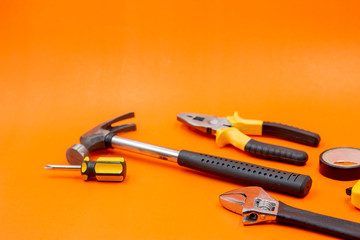 Mechanic kit tools are on orange background