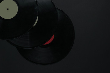 Vinyl records on black background. Top view