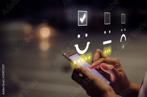 Fotografía Businesswoman pressing smiley face emoticon on virtual touch screen