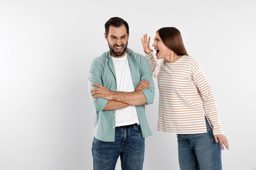 Wall Mural - Couple quarreling on light background. Relationship problems