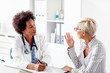© pucko_ns - Mature woman talk with her doctor about health in clinic