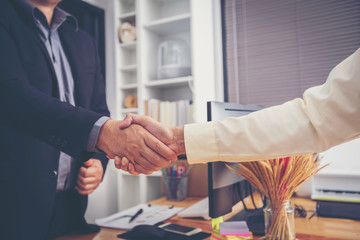 Businessmen shaking hands After successfully completing the investment and life insurance contract at office