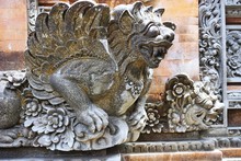 Ancient Carved Stone Winged Gargoyle At A Temple In Bali Indonesia
