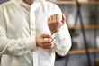 © bondvit - businessman dresses white shirt, male hands closeup,groom getting ready in the morning before wedding ceremony