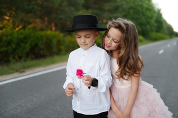 Wall Mural - young happy boy and girl together outside