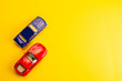 © stenkovlad - two toys cars on yellow background
