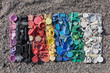 gradient color of plastic parts, degraded still life of plastic caps and different plastic pieces found on the beach, aerial view of the still life of plastic pieces found on the beach
