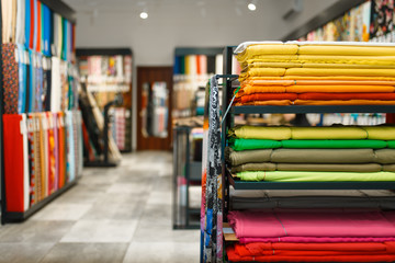 fabric on shelves in textile store, nobody