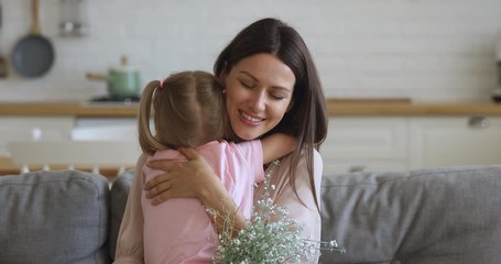 Canvas Print - Sincere young mother embracing cuddling little preschool daughter.