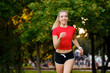 © Ilnur - A young girl goes in for sports outdoors. woman in shorts and red t-shirt runs in nature