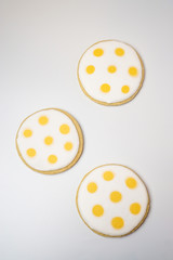 Cookies decorated with white and yellow polka dots