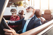 © Alessandro Biascioli - Happy senior couple having fun on new convertible car - Mature people enjoying time together during road trip vacation - Elderly lifestyle and travel transportation concept