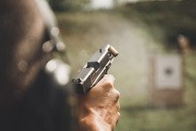 Close-Up Of Person Holding Gun