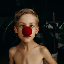 Close-Up Portrait Of Boy Wearing Red Nose