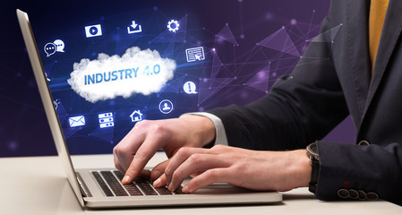 businessman working on laptop with industry 4.0 inscription, modern technology concept
