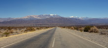 Empty Road, Colored Mountain Chain, Huge Dry Field And The Glacier Behind, On The Route 33, Salta, Argentina