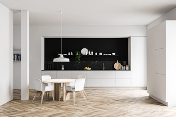 White and black kitchen, column and dining table