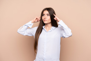 Wall Mural - Young woman over isolated background having doubts and thinking