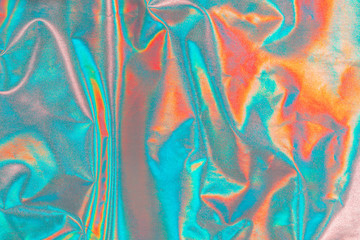 Iridescent fabric trendy holographic cloth background. Colorful chrome fabric.
