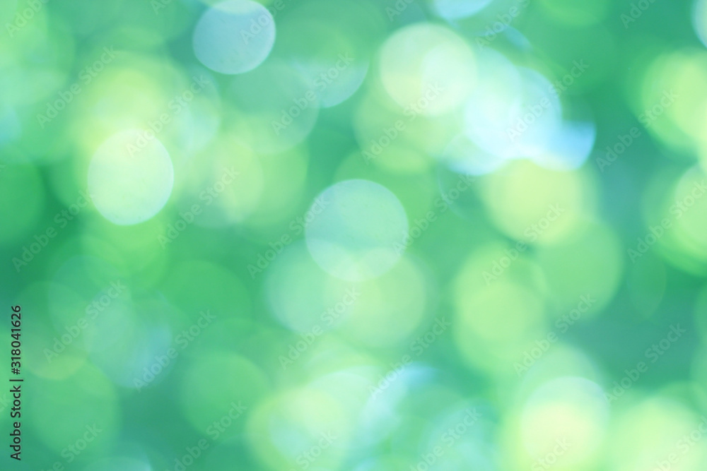 Abstract bokeh, natural green and blue background, beautifully blurred during the summer, which is a blue-green bokeh taken from the leaves on the tree and has a yellow-blue light - obrazy, fototapety, plakaty 