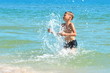 © Victoria - A little boy playing in the sea water. A child jumps from the sea. A tropical vacation with children.
