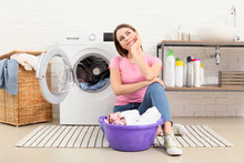 Young Housewife Washing Laundry At Home