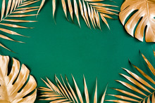 Gold Tropical Palm Leaves Monstera On Green Background. Flat Lay, Top View Minimal Concept.