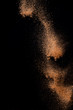 © PINKASEVICH - Cocoa powder explosion in motion on black background. Chocolate dust.