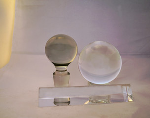 Crystal Still Life:  a prism laying in front of two crystal spheres.