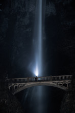 Low Angle View Of Bridge Against Waterfall At Night