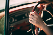 Cropped Hand Of Woman Holding Steering Wheel In Car