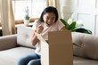 Excited asian girl overjoyed with online order package
