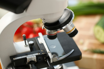 microscope head on kitchen background vegetables concept nitrates